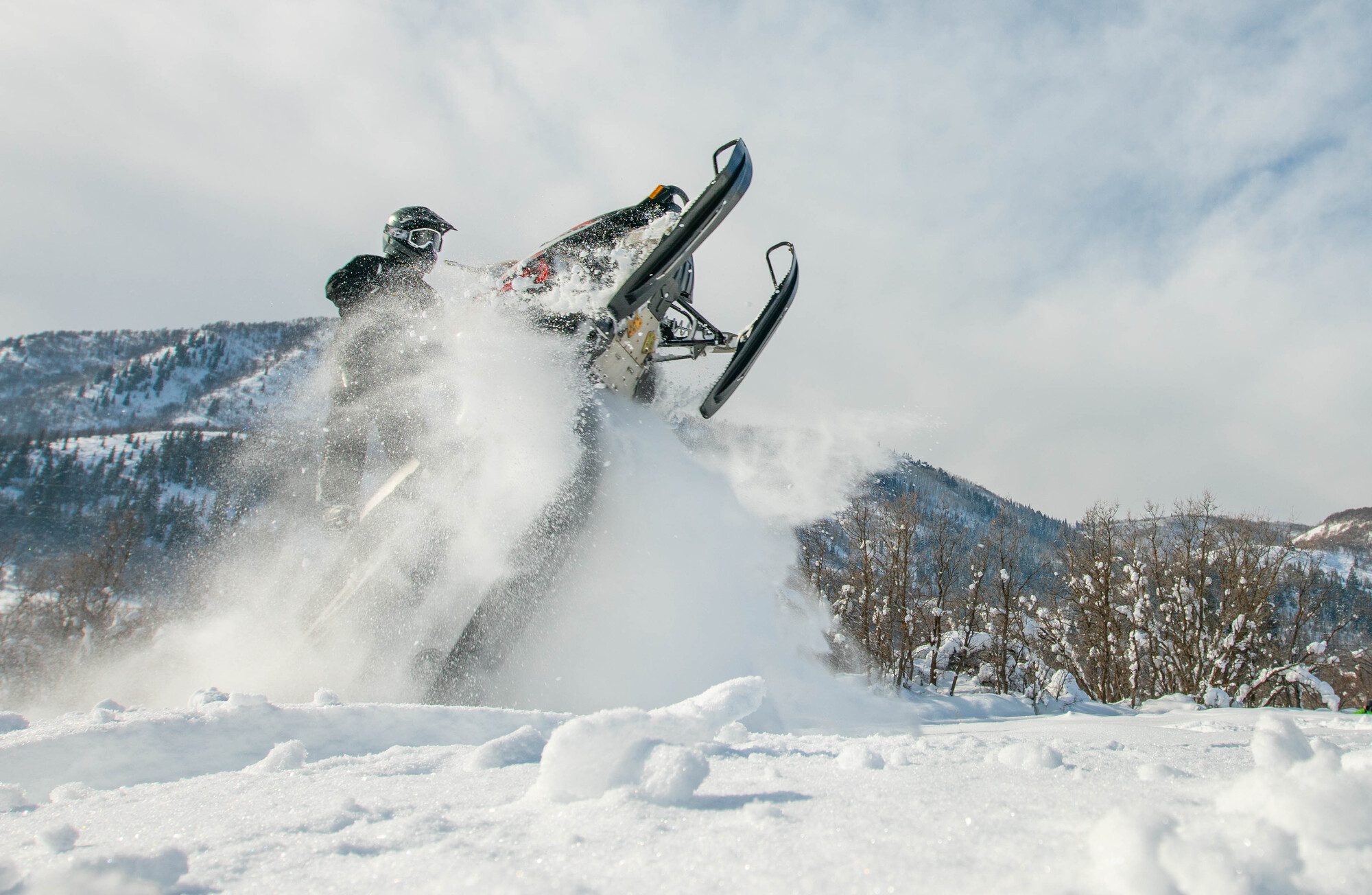 Snowmobile rider in Utah wearing a helmet, Utah outdoor recreation.