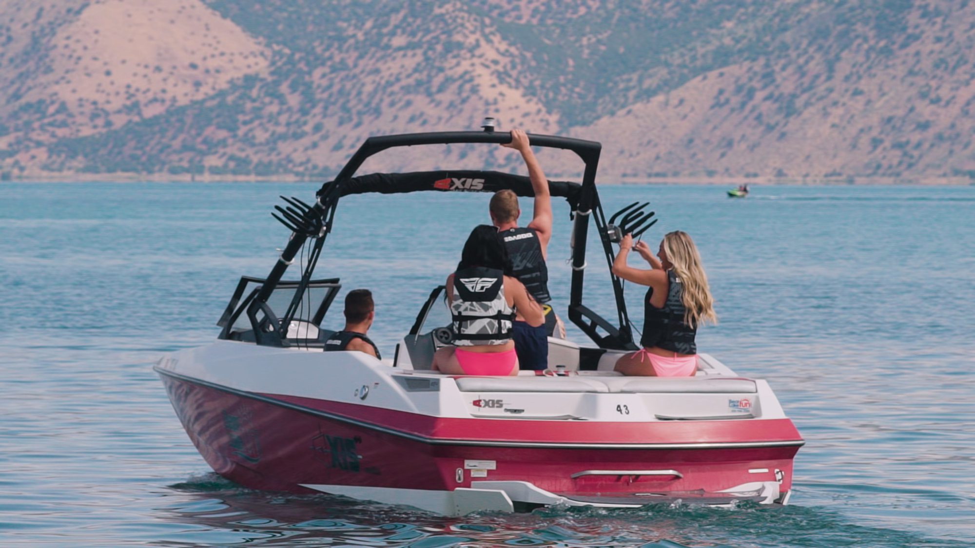 Utah boaters participating in Utah outdoor recreation on a lake wearing lifejackets.